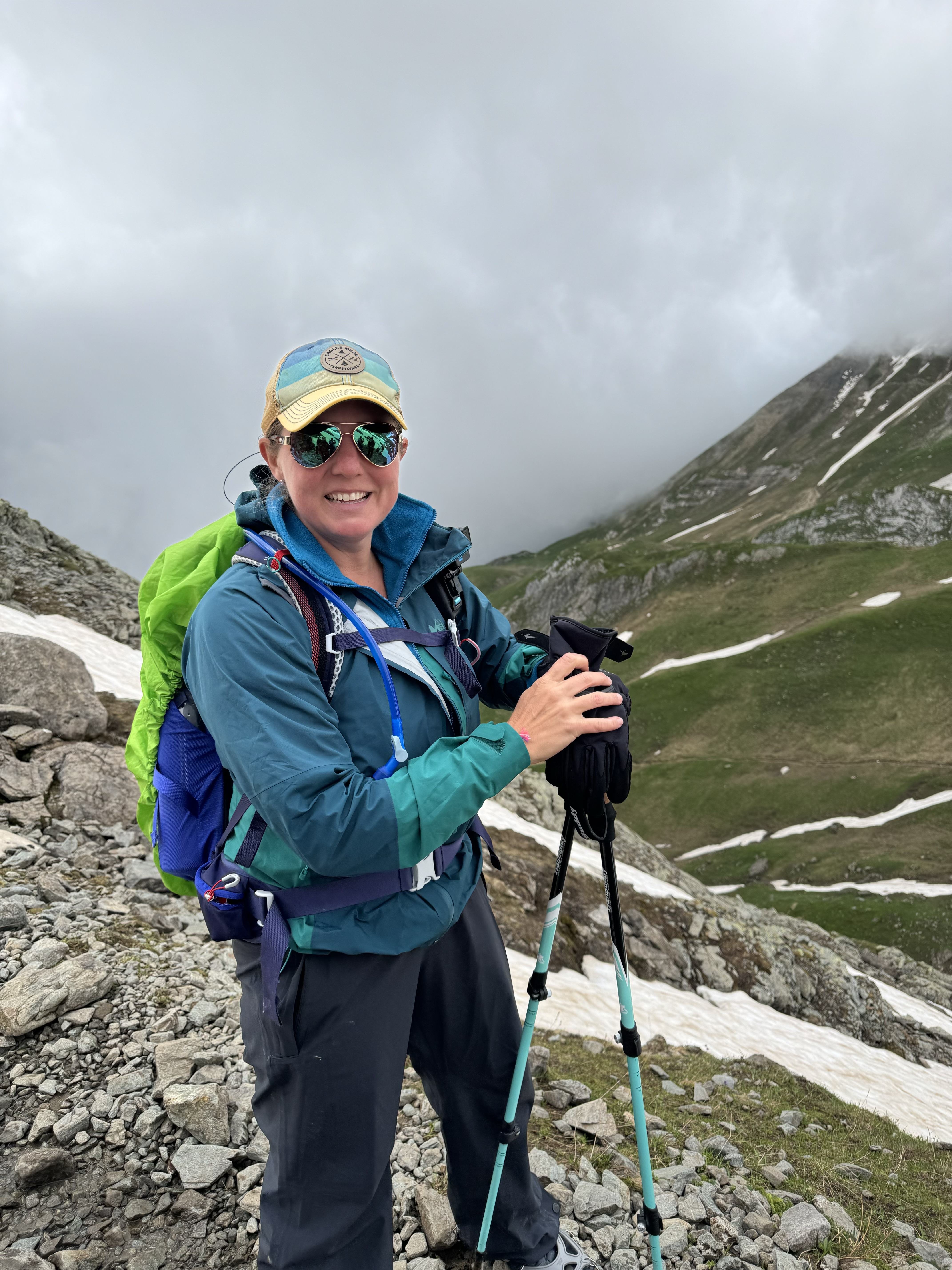 Osprey Sirrus backpack, rain gear and trekking poles on the Tour du Mont Blanc